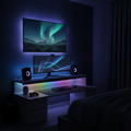 RGB LED strip lights glowing behind a TV and desk in a modern bedroom